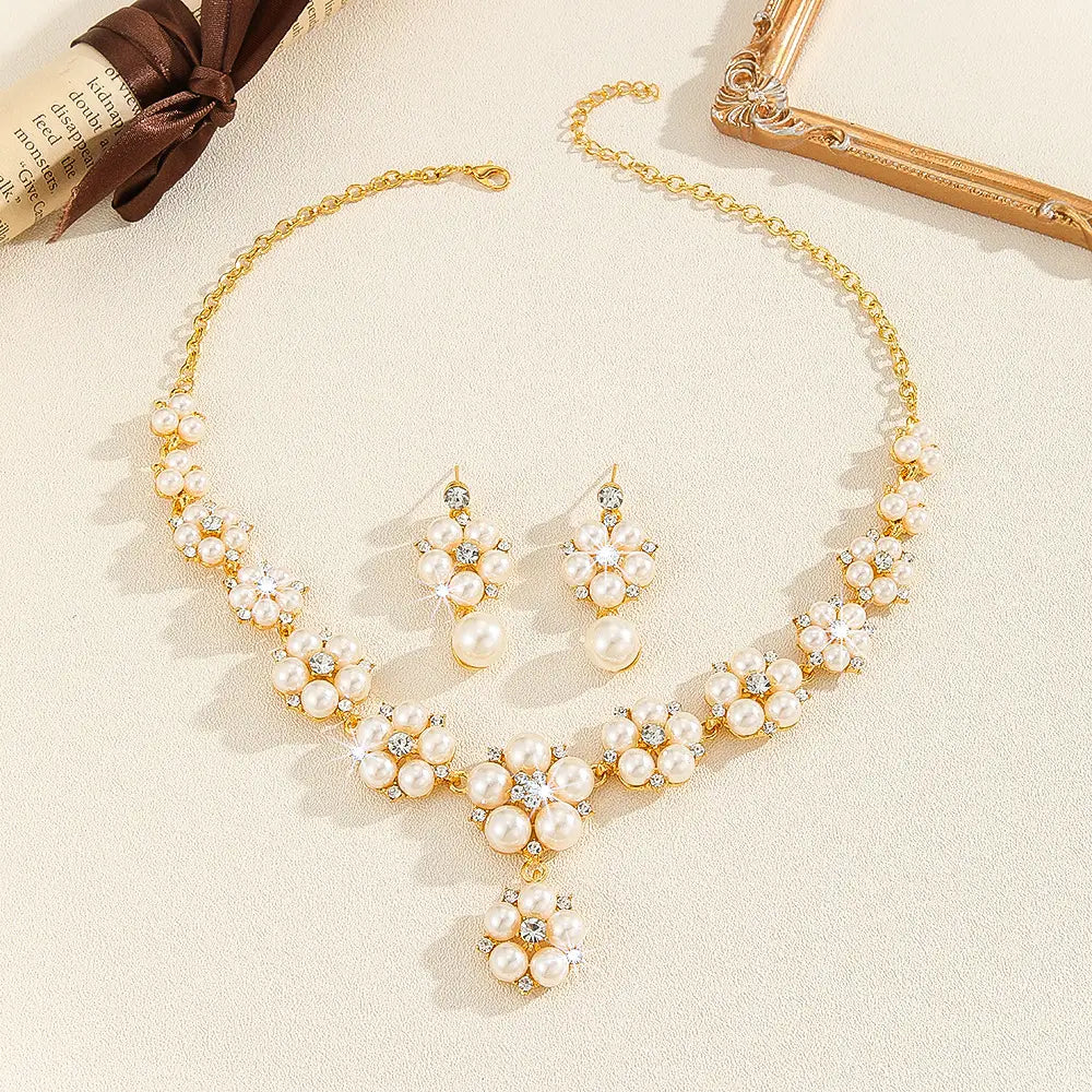 Pearl necklace and earrings set on a beige surface