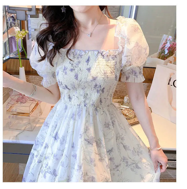 Woman wearing a floral off-shoulder dress in an indoor setting