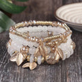 4-piece bohemian beaded bracelet stack with white resin beads and gold leaf charms