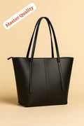Black tote bag on a beige background with 'Master Quality' label.