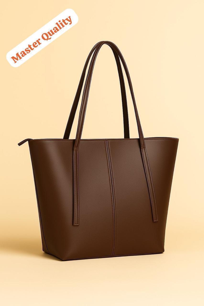 Brown tote bag on a beige background with 'Master Quality' label.