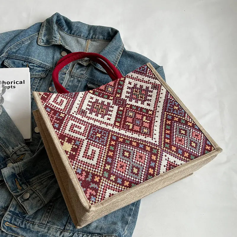 Decorative box with geometric pattern on a denim jacket and white surface