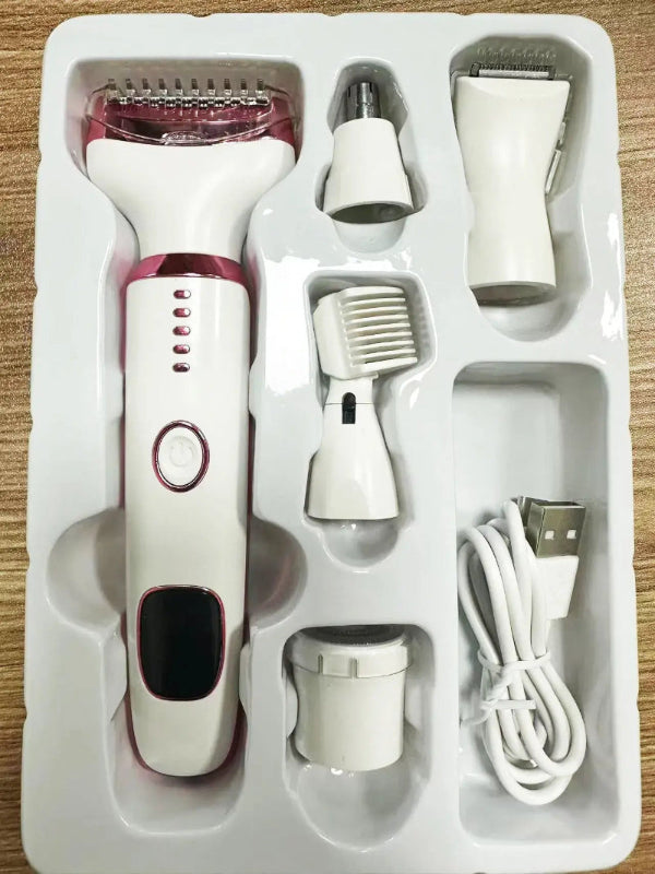Electroshaver set with multiple attachments in a white box on a wooden surface