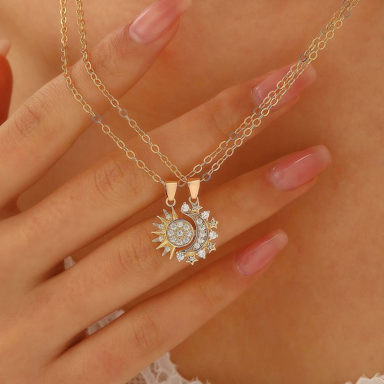 Gold chain necklace featuring a blue crystal sun and crescent moon design.