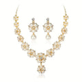 Gold-plated pearl jewelry set featuring a choker necklace and matching drop earrings, decorated with faux pearls and clear rhinestones on a white background.