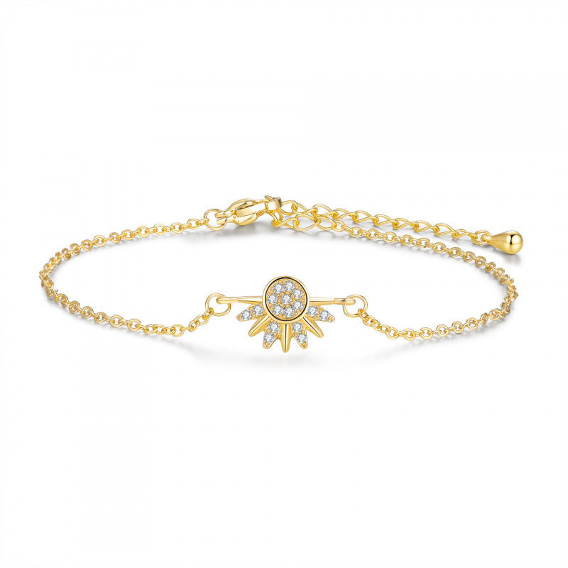 Gold bracelet with a decorative clasp on a white background