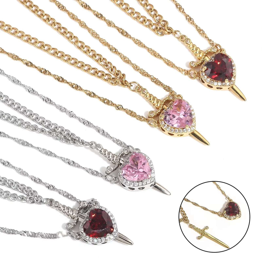 Heart-shaped gemstone necklaces in gold, silver, and rose gold on a white background.