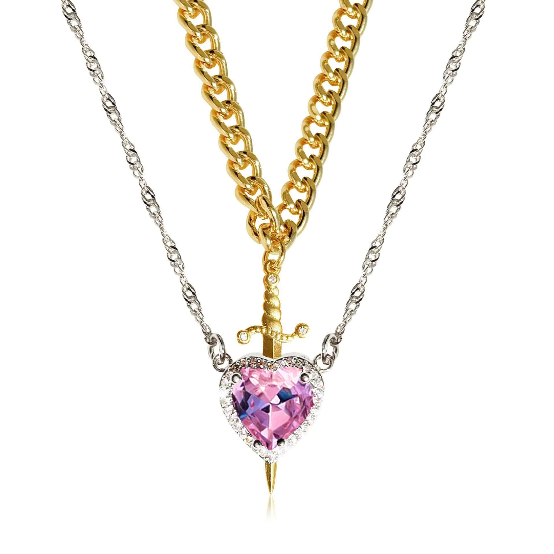 Necklace with a heart-shaped pink gem and gold chain on a white background