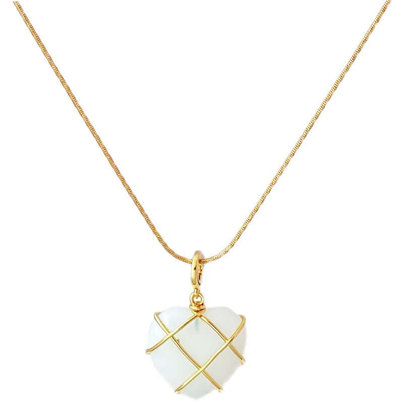 Necklace with a white heart-shaped pendant on a gold chain against a white background