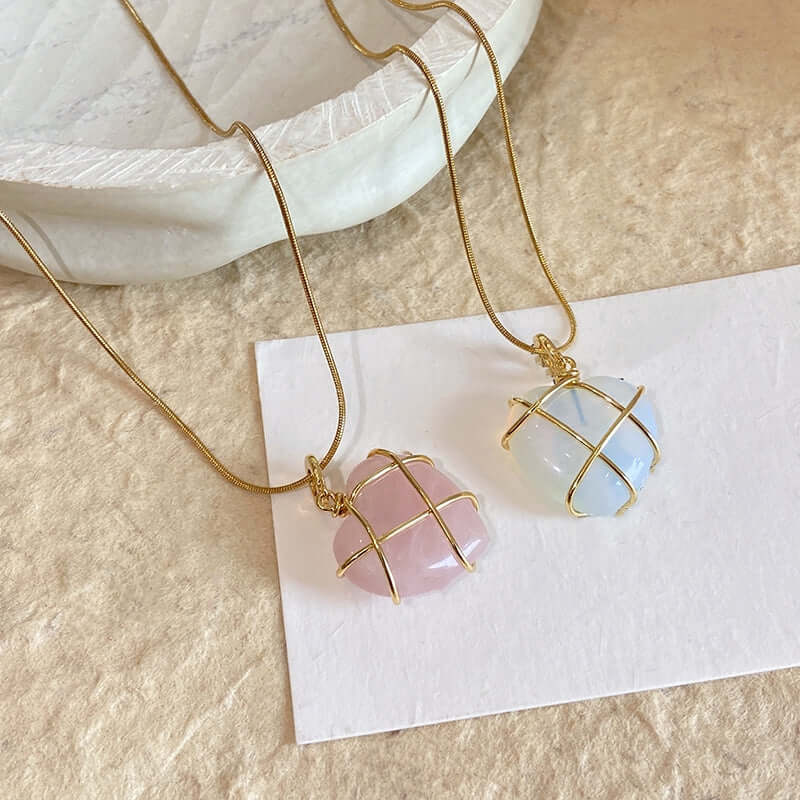 Necklace with pink and blue stone pendants on a white card
