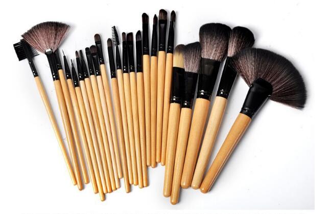Set of makeup brushes with wooden handles on a white background