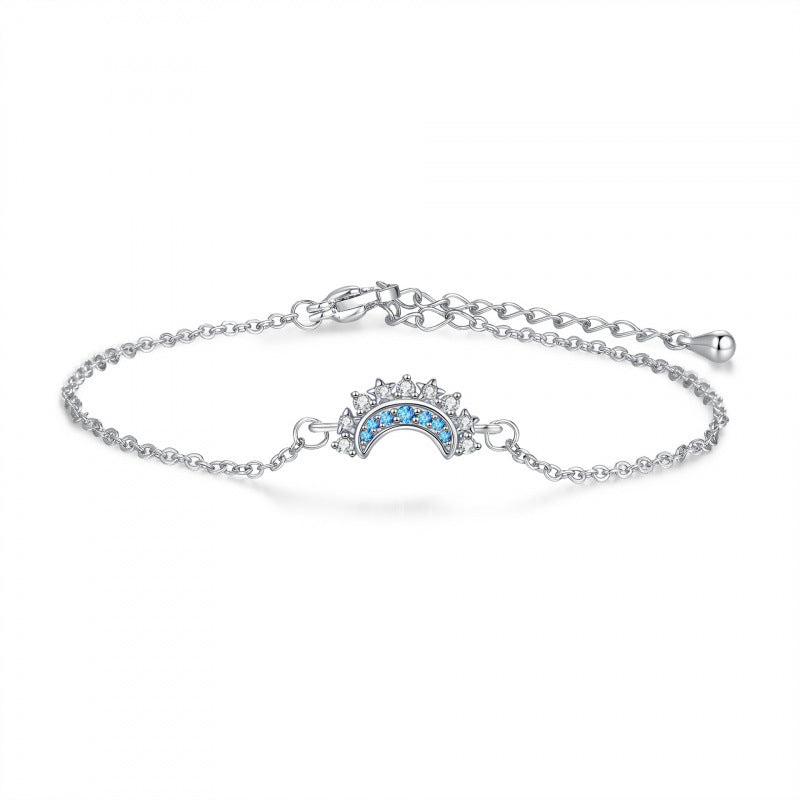 Silver bracelet with a blue gemstone on a white background