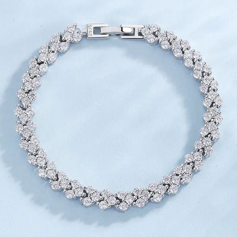 Silver bracelet with clear gemstones on a light blue background