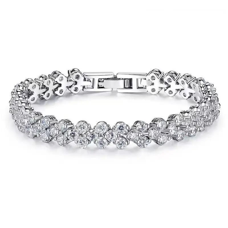 Silver bracelet with clear stones on a white background