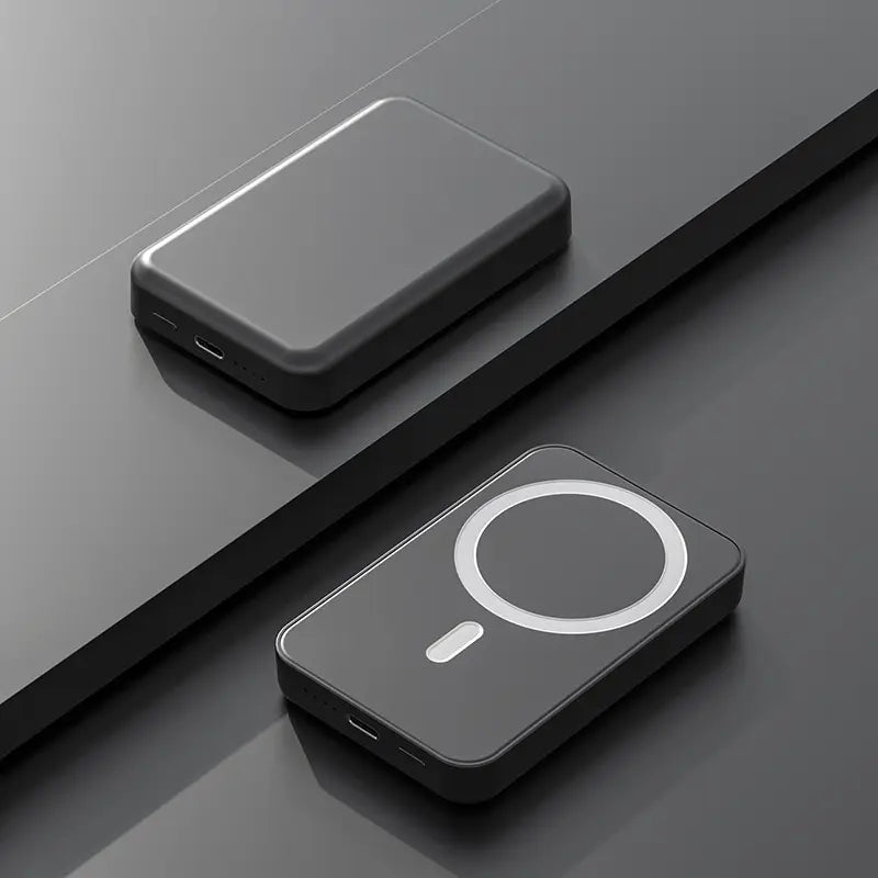 Two black rectangular devices on a reflective gray surface