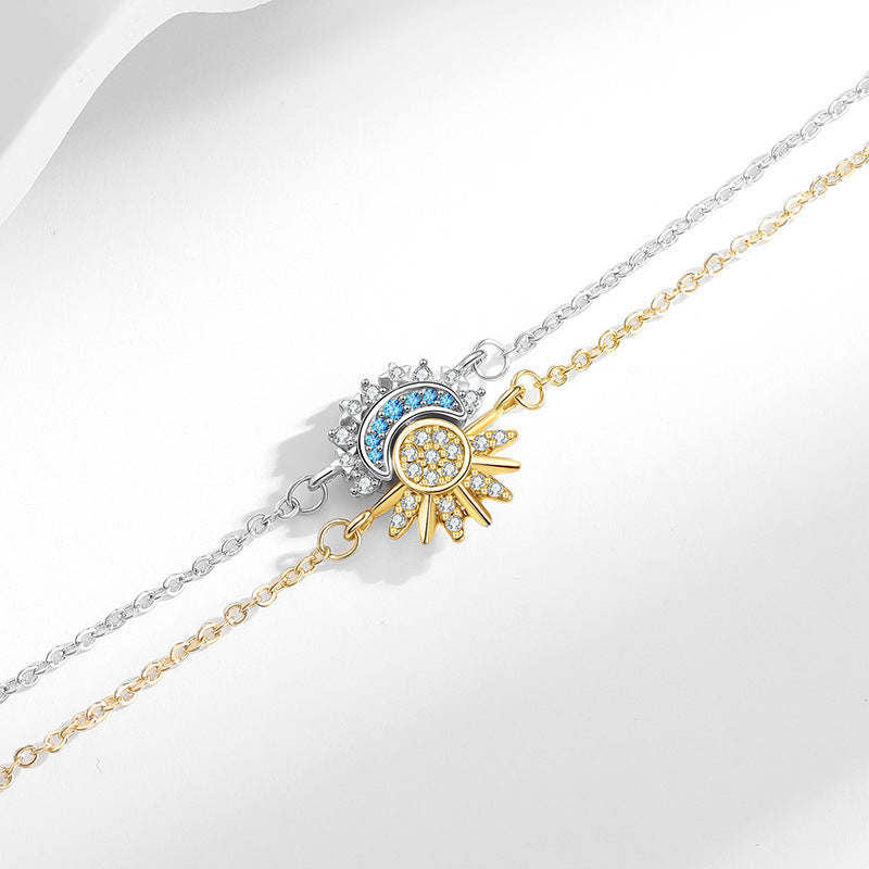 Delicate gold and blue crystal charm chain bracelets stacked together