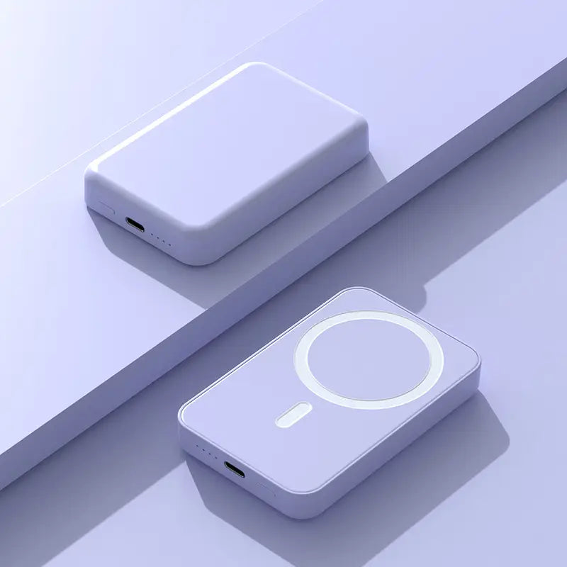 Two wireless charging devices on a light purple surface