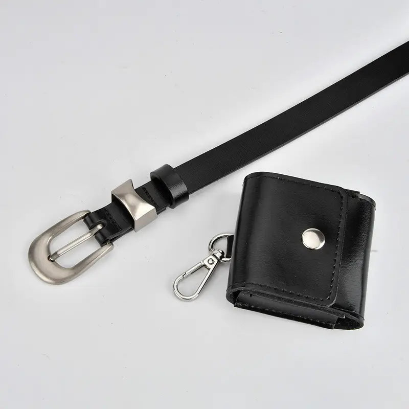 A black leather belt with a silver buckle shown next to a matching black leather wallet or card holder with a silver snap button and clip, on a light gray background.