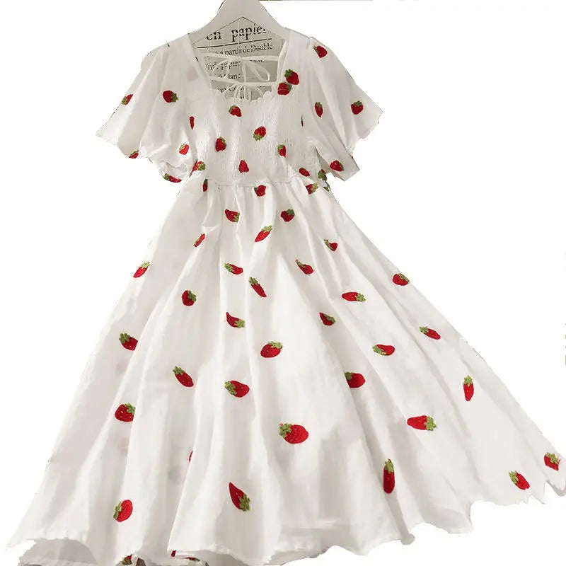 White dress with strawberry pattern on a white background