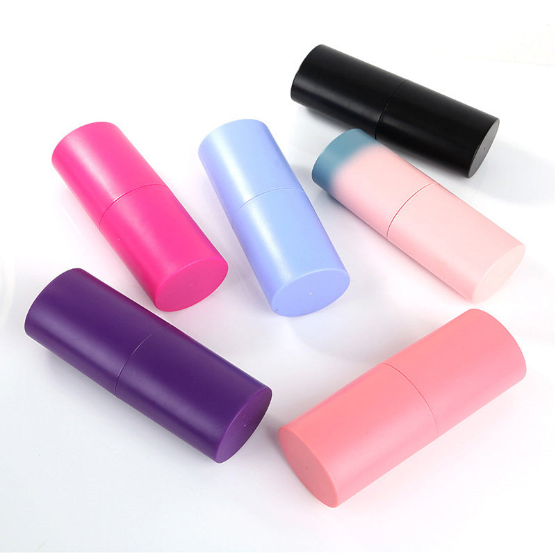 Collection of colorful cylindrical makeup brush cases including blue, pink, black, and white options.