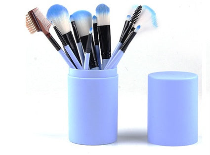  Light blue travel brush holder filled with makeup brushes alongside its matching detachable top cover
