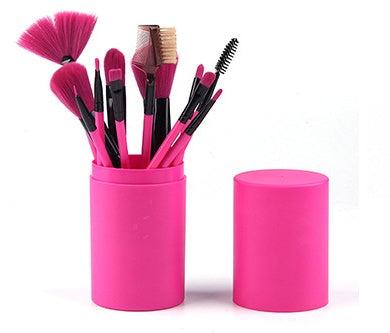 Vibrant hot pink cylindrical brush cup packed with cosmetic brushes