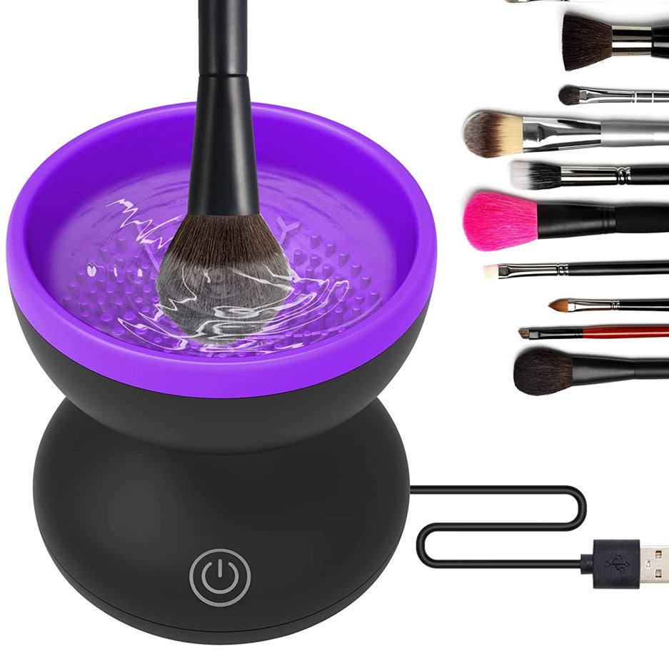  Black electric makeup brush cleaner unit with purple internal LED illumination while cleaning a brush.