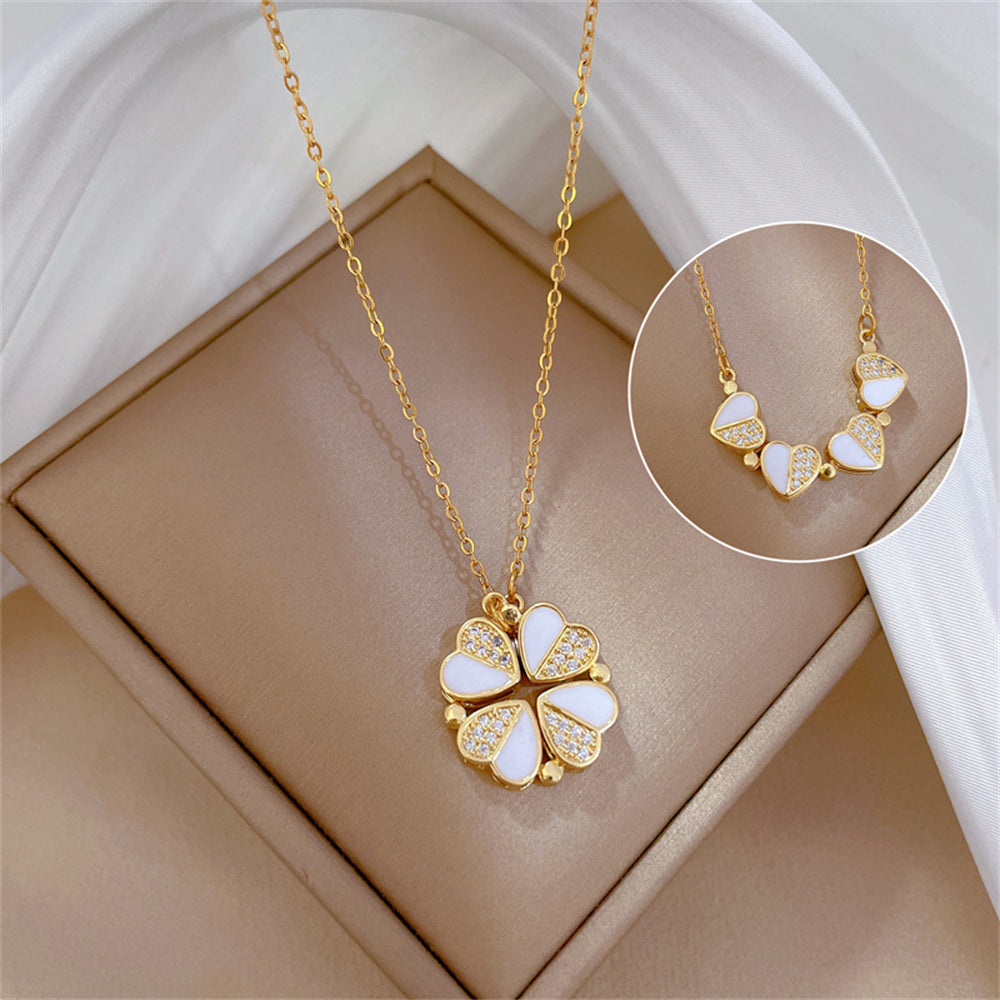  Gold magnetic 2-in-1 four-leaf clover pendant shown in both closed clover and open four-heart styles on a pink jewelry gift box.