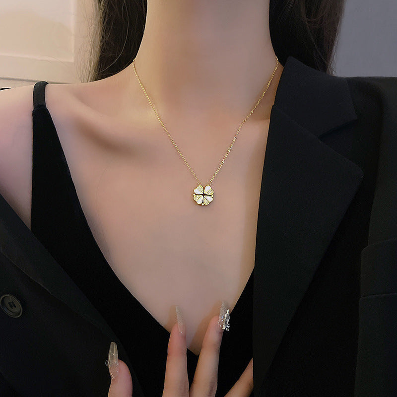 Minimalist view of thin gold chain necklace with four small hearts arranged in a horizontal row.