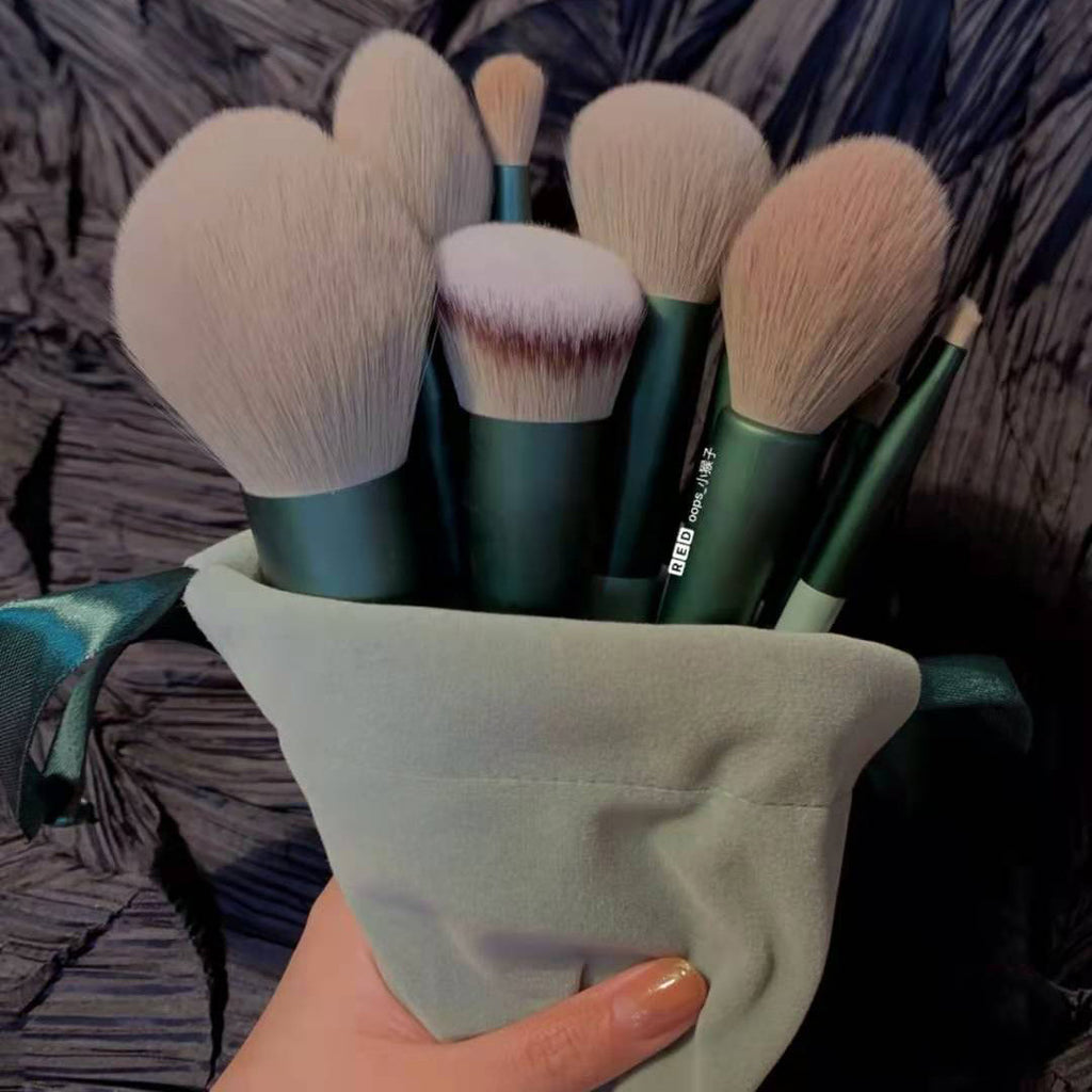 Makeup brush set held inside a cloth storage bag under soft lighting.