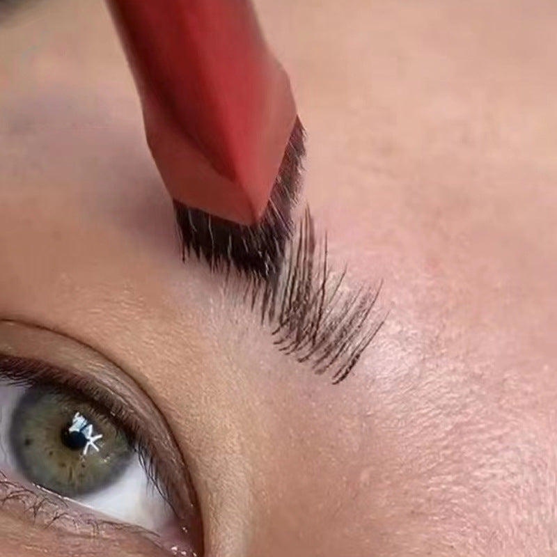 Macro close-up shot of applying brow gel to natural eyebrow hair.