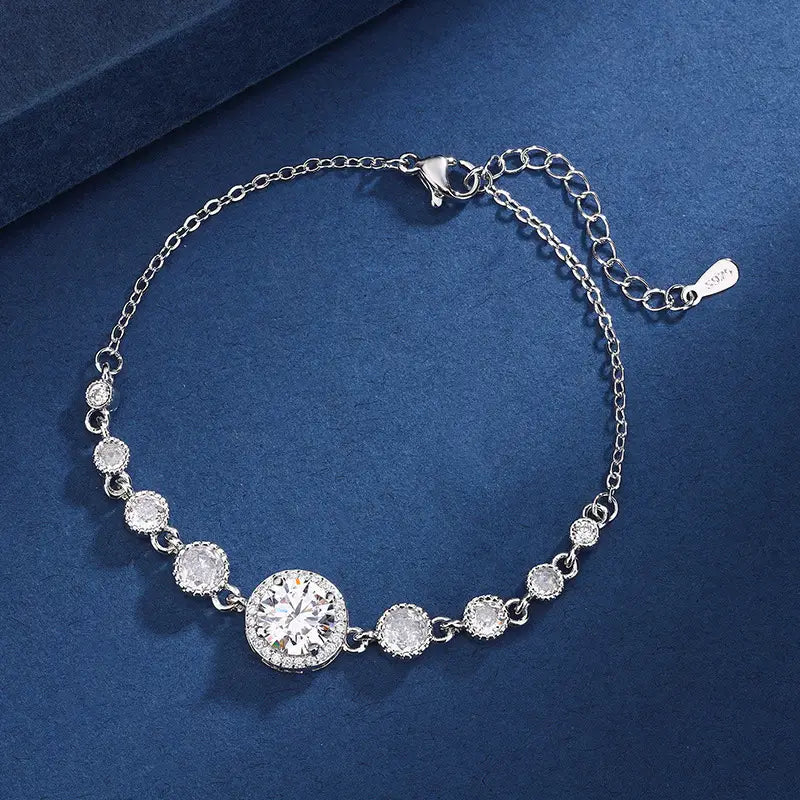 Silver bracelet with clear stones on a blue background
