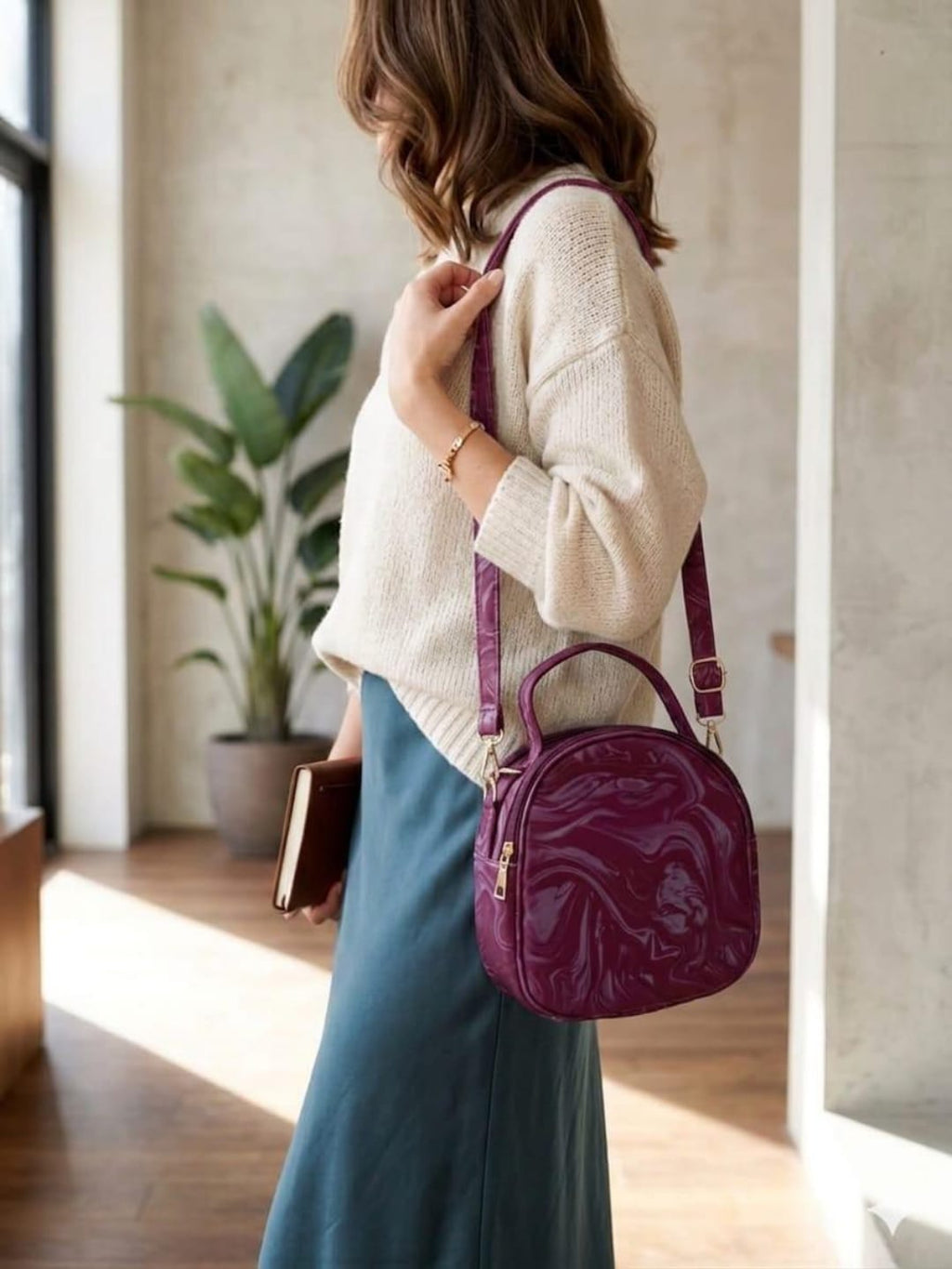Woman wearing purple round crossbody bag