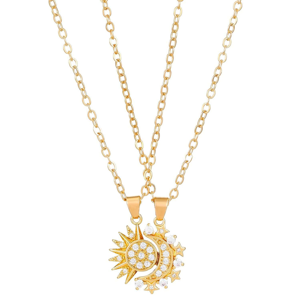  Person holding a silver and crystal sun and moon charm necklace on delicate chain.
