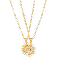 Person holding a silver and crystal sun and moon charm necklace on delicate chain.